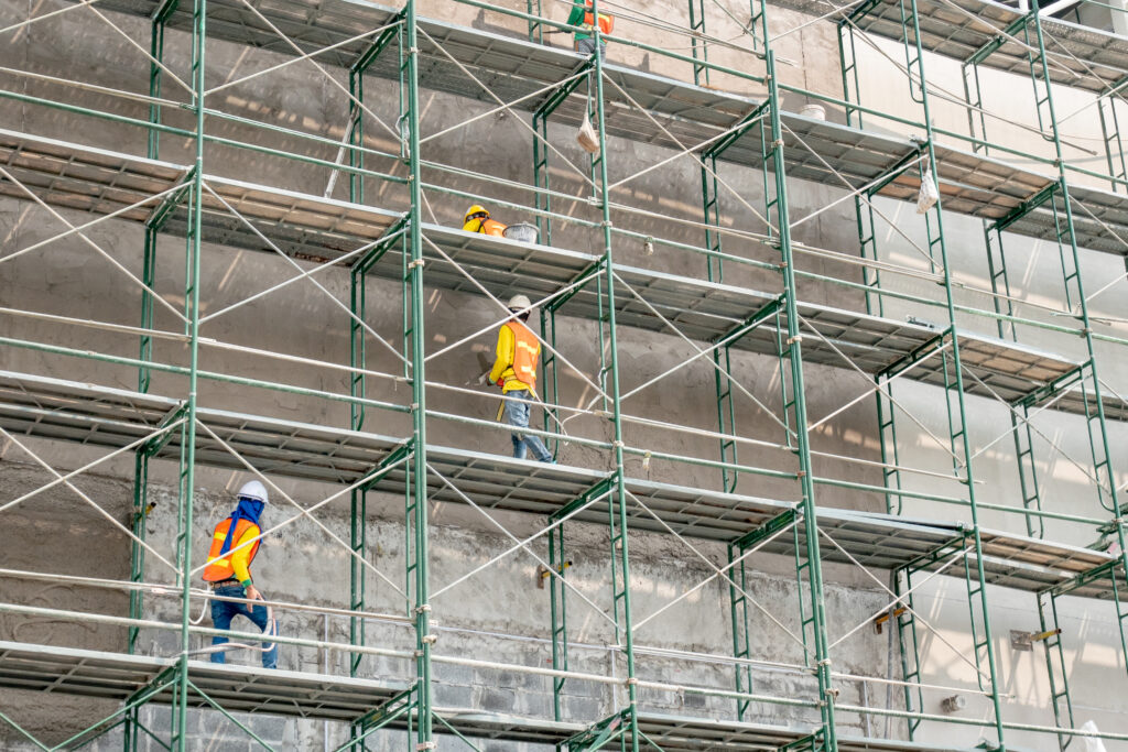 Construction Workers Navigating Scaffolding