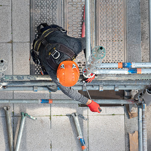 technician installing ring lock scaffolding